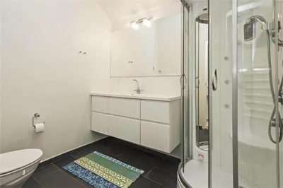 a bathroom with a shower and a sink and a toilet at BL655-Blokhus-Sdr-Strandvej-11 in Blokhus