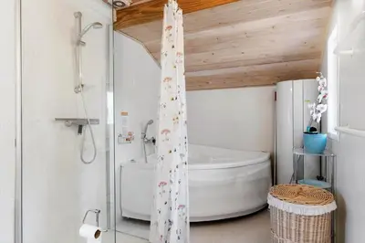 a bathroom with a shower and a toilet in it at BL1329-Blokhus-Pirupshvarrevej-67 in Blokhus