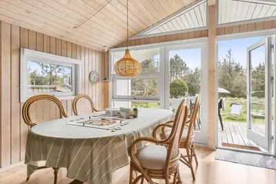 a dining room with a white table and chairs at BL812-Blokhus-Morten-Nielsensvej-10 in Blokhus
