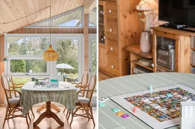 a kitchen and a dining room with a table at BL812-Blokhus-Morten-Nielsensvej-10 in Blokhus