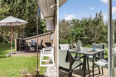 a patio with a table and chairs and an umbrella at BL812-Blokhus-Morten-Nielsensvej-10 in Blokhus