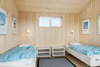 a bedroom with two beds and a window at BL161-Saltum-Taarnfalkevej-16 in Saltum