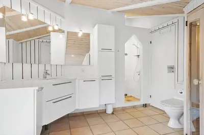 a white bathroom with a sink and a toilet at BL161-Saltum-Taarnfalkevej-16 in Saltum