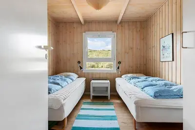 two beds in a room with a window at BL1661-Saltum-Klitrosevej-11 in Saltum