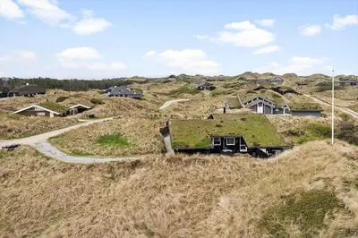 a house with a grass roof on a hill at BL168-Saltum-Taarnfalkevej-11 in Saltum