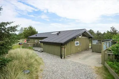 a large green building with a black roof at BL173-Blokhus-Bloksbjerg-88 in Blokhus