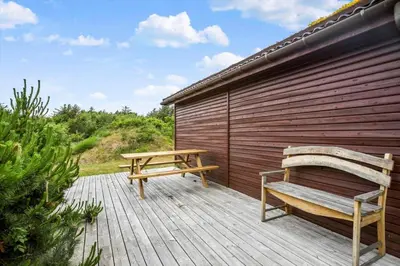 a wooden deck with a bench and a picnic table at BL1568-Saltum-P-Ejerstedgaardsvej-1-A in Saltum
