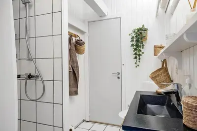 a bathroom with a sink and a shower at BL1271-Blokhus-Axel-P-Jensenvej-3 in Blokhus
