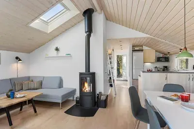 a living room with a couch and a fireplace at BL1272-Pandrup-Kirkekrogen-7 in Pandrup