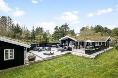 a backyard of a house with a large patio at BL1280-Blokhus-Bloksbjerg-50 in Blokhus