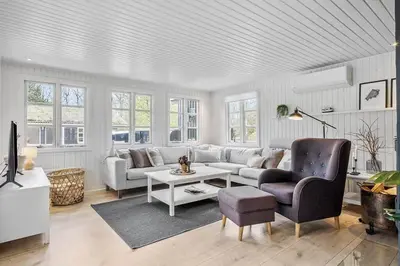 a living room with a couch and a table at BL1280-Blokhus-Bloksbjerg-50 in Blokhus