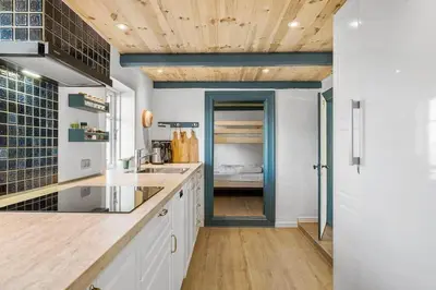 a kitchen with white cabinets and a wooden ceiling at BL1249-Pandrup-Rodhus-Klitvej-80 in Pandrup