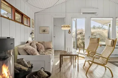 a living room with a couch and a fireplace at BL1173-20-Pandrup-Hunetorp-Klitvej-119 in Pandrup