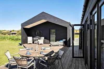 a patio with a table and chairs on a deck at BL1288-Saltum-Tolhoj-48 in Saltum
