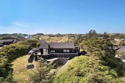 a house sitting on top of a hill at BL1100-Blokhus-Klitvejen-44 in Blokhus