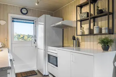 a kitchen with white cabinets and a white refrigerator at BL1523-Saltum-Skanderborgvej-14 in Saltum