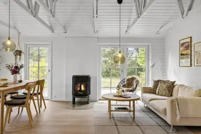 a living room with a couch and a fireplace at BL1109-Blokhus-Bag-Hojen-78 in Blokhus