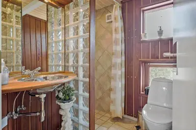 a bathroom with a sink and a toilet at BL1102-Blokhus-Solbakkevej-17 in Blokhus