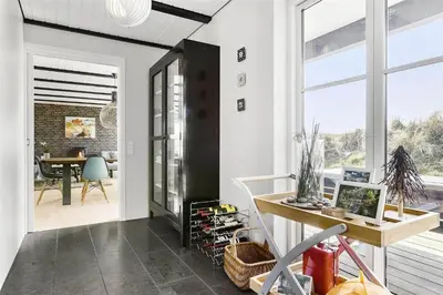 a home office with a desk and a table at BL1310-Blokhus-Moreavej-33-A in Blokhus