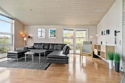 a living room with a couch and a table at BL271-Blokhus-Taarnfalkevej-15 in Blokhus