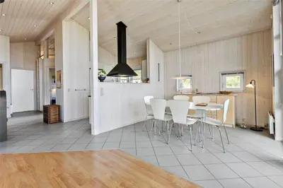 a kitchen and dining room with a table and chairs at BL271-Blokhus-Taarnfalkevej-15 in Blokhus