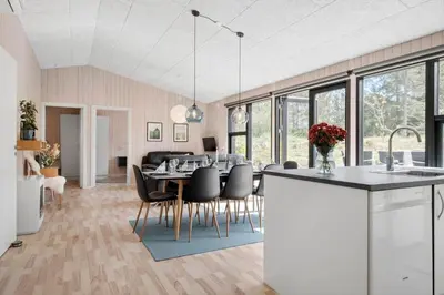 a kitchen and dining room with a table and chairs at BL1765-Blokhus-Plantagevej-2B in Blokhus
