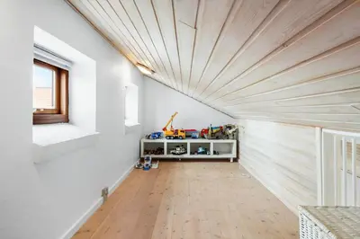 a room with white walls and a wooden ceiling at BL1117-Blokhus-Peter-Andersensvej-10 in Blokhus