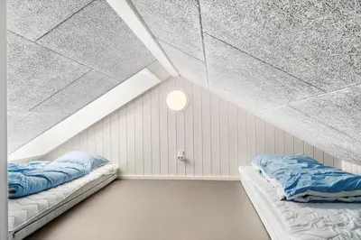 two beds in a room with a attic at 336-Harboore-Hvilehjemsvej-23 in Harboør