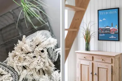 a living room with a chair and a picture of a house at 336-Harboore-Hvilehjemsvej-23 in Harboør