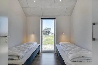 a row of beds in a room with a window at 340-Harboore-Byskovvej-40 in Harboør