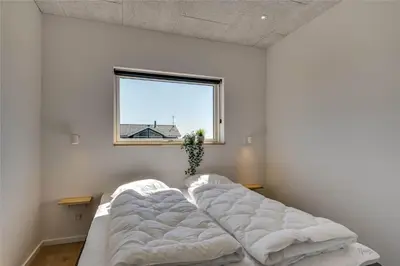 a bedroom with two beds in front of a window at 340-Harboore-Byskovvej-40 in Harboør