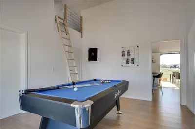 a pool table in a room with a ladder at 340-Harboore-Byskovvej-40 in Harboør