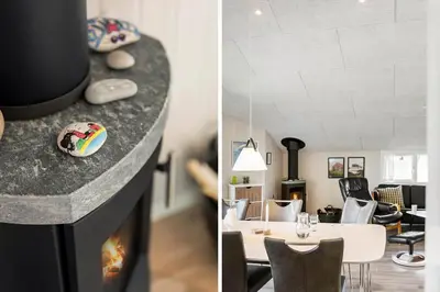 a living room with a fireplace and a dining room at 168-Harboore-Emblavej-1 in Harboør