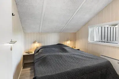 a bedroom with a bed in a small room at 168-Harboore-Emblavej-1 in Harboør