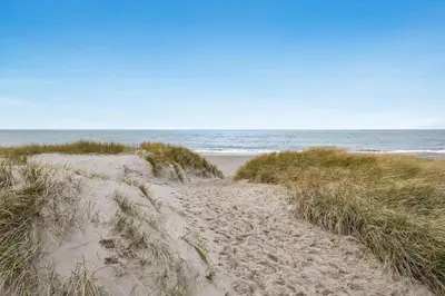 a sandy path leading to a beach with the ocean at 168-Harboore-Emblavej-1 in Harboør