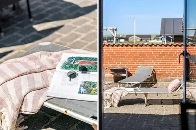a picnic table with a blanket and a table with a book at 159-Harboore-Alkajavej-6 in Harboør