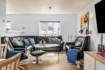 a living room with leather furniture and a table at 159-Harboore-Alkajavej-6 in Harboør