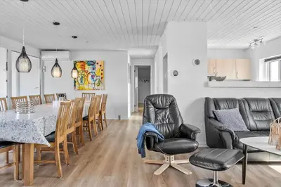 a kitchen and dining room with a table and chairs at 159-Harboore-Alkajavej-6 in Harboør