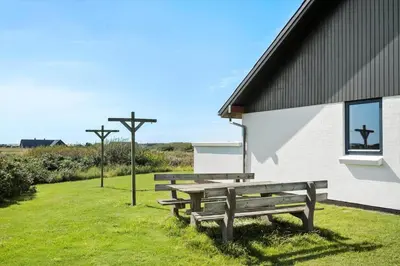 a group of benches sitting outside of a building at 115-Harboore-Strandvejen-164 in Harboør