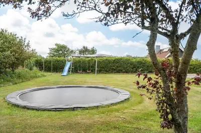 a trampoline in the middle of a yard at 600-Lemvig-Porsevej-115 in Lemvig