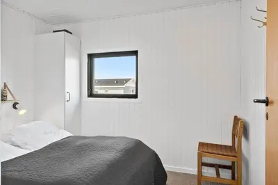 a white bedroom with a bed and a window at 157-Harboore-Vejlby-Klit-65 in Harboør