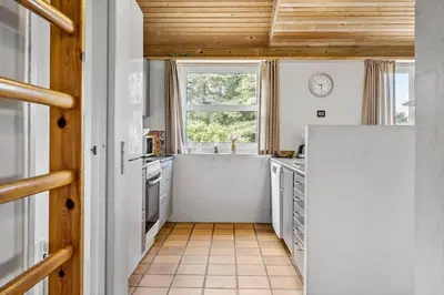 a kitchen with a white refrigerator and a window at 203-Harboore-Viktoriavej-3 in Harboør