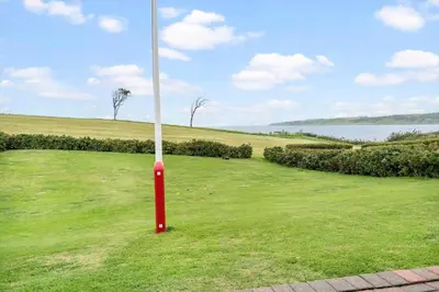 a red pole in the middle of a grass field at G431-Lemvig-Gyvelvej-31 in Lemvig