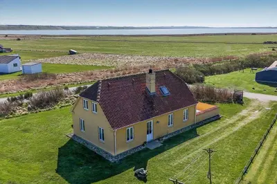 an aerial view of a large yellow house in a field at 283-Harboore-Neerlandiavej-130 in Harboør