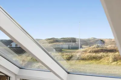 a window in a house with a view of the desert at 254-Harboore-Vejlby-Klit-251 in Harboør