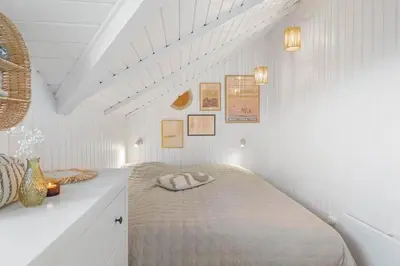 a bedroom with a bed in a white room at 254-Harboore-Vejlby-Klit-251 in Harboør