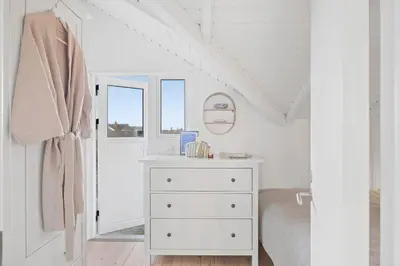 a white bedroom with a white dresser and a window at 254-Harboore-Vejlby-Klit-251 in Harboør