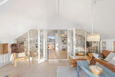 a living room with a couch and a table at 254-Harboore-Vejlby-Klit-251 in Harboør
