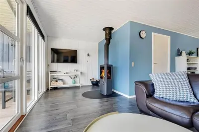 a living room with a couch and a fireplace at 235-Harboore-Vejlby-Klit-139 in Harboør