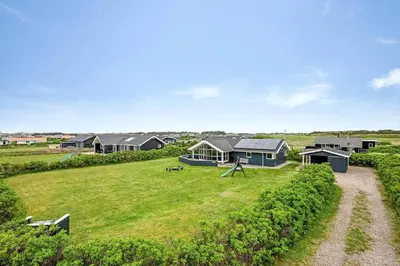 an aerial view of a house in a grassy field at 234-Harboore-Neerlandiavej-21 in Harboør